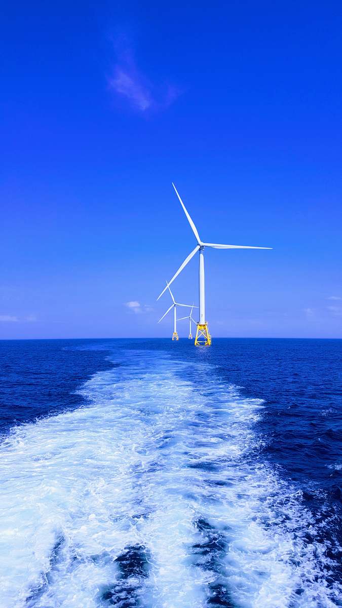 wind turbine three white wind turbine on sea engine